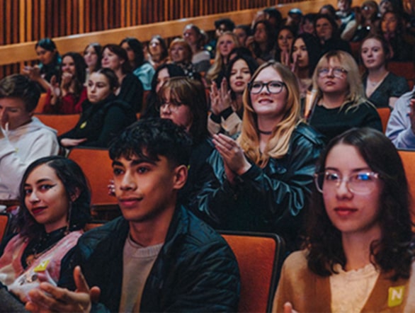 students in audience applauding