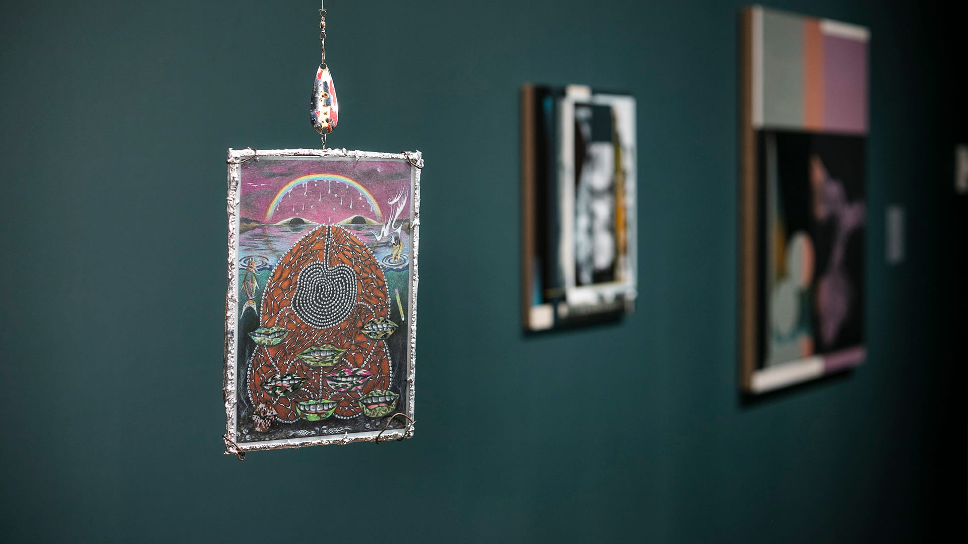 artwork hanging on green wall