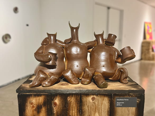 horned metal figures on rope with shadows