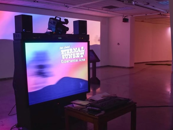 tv screen with text "external sunset" and sunset background