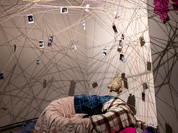 string art with polaroid prints hanging from them