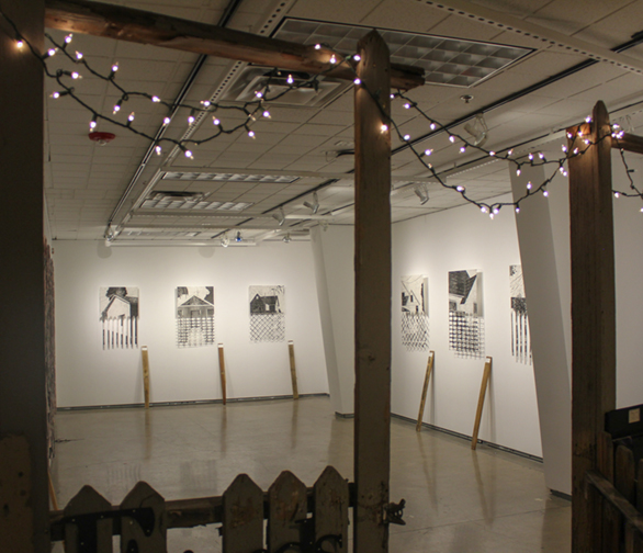 black and white artwork on walls with white lights above