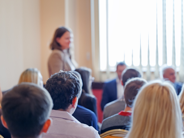 woman presenting in front of audience