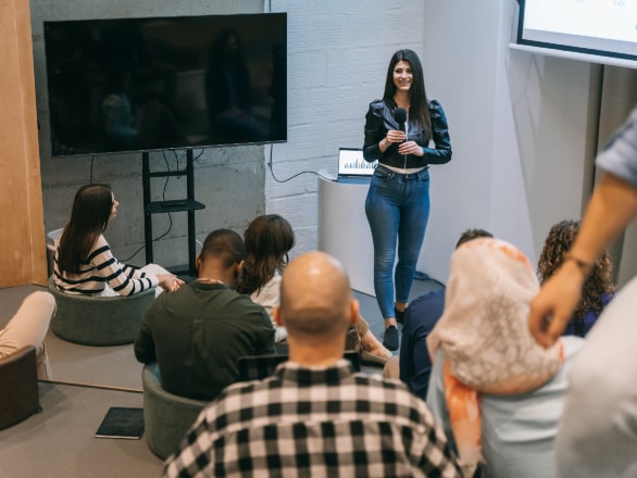 woman speaking in front of small audience