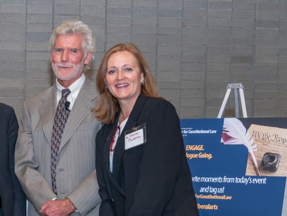 man and woman side by side smiling at camera