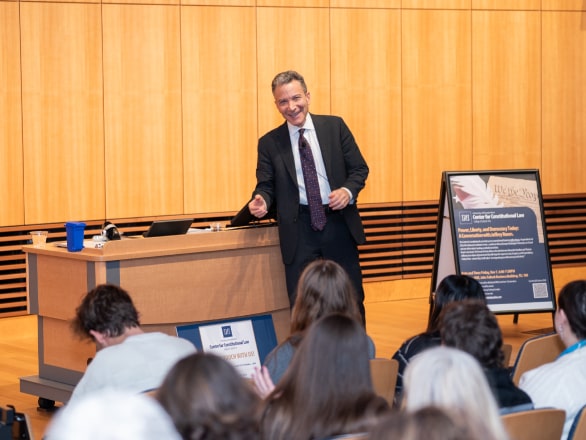 man speaking in front of crowd