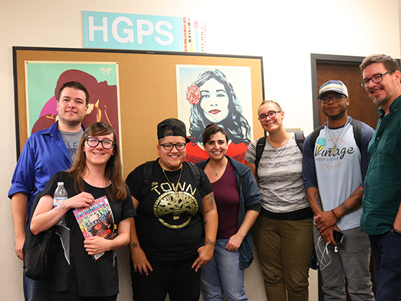 MFA students and professor stand next to Gabby Rivera