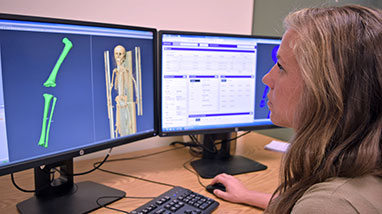 Kyra Stull looks at bone scans on computer