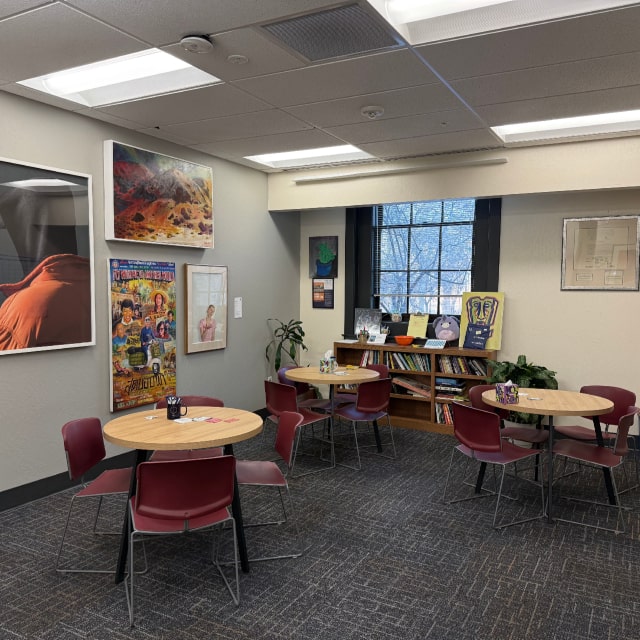 lounge area with tables and chairs and art on walls