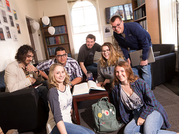 Group of students sit together in the Shared History room