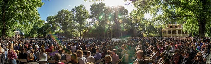 audience watching graduation on the quad