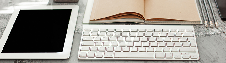 tablet next to keyboard