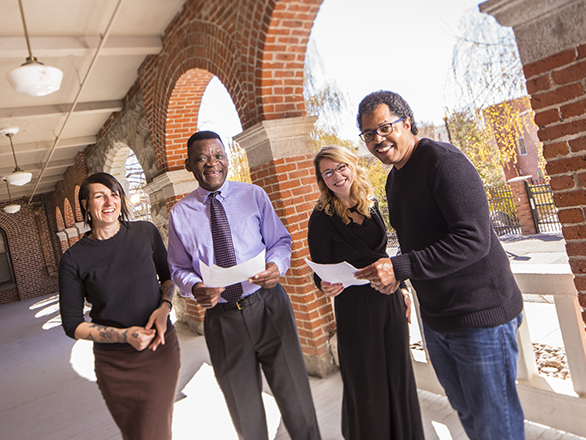 Faculty with grad students on porch at Lincoln Hall