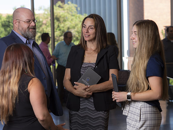 Interim Dean Cassie speaking with students and faculty