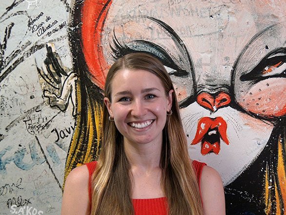 Ivy standing in front of art mural