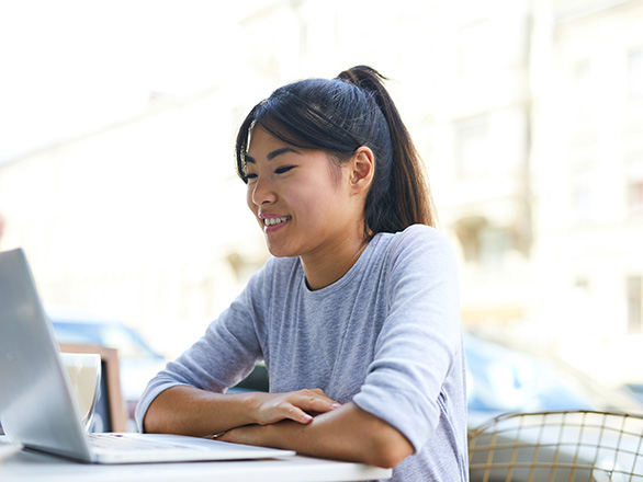 Woman watching computer at desk