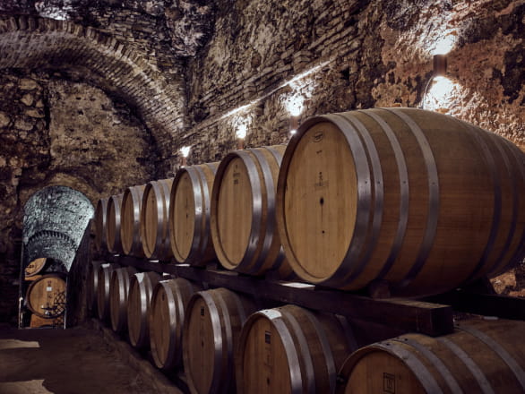 wine barrels in brick storage room