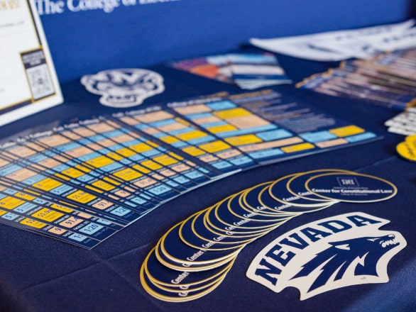 marketing materials on a table with nevada wolf logo