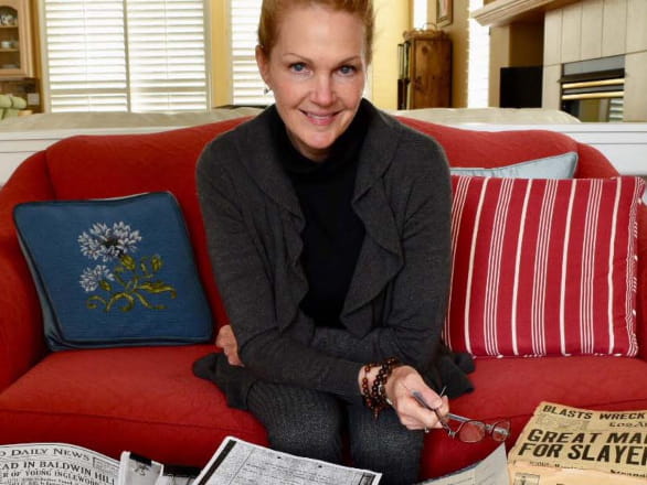 woman smiling on red couch