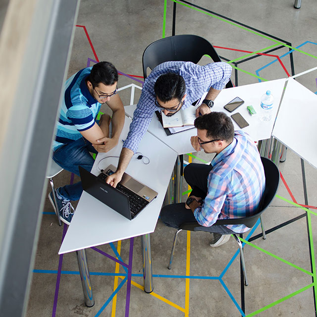 People working together at a computer desk