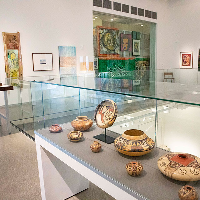 Art museum featuring glass display case with Native American artifacts