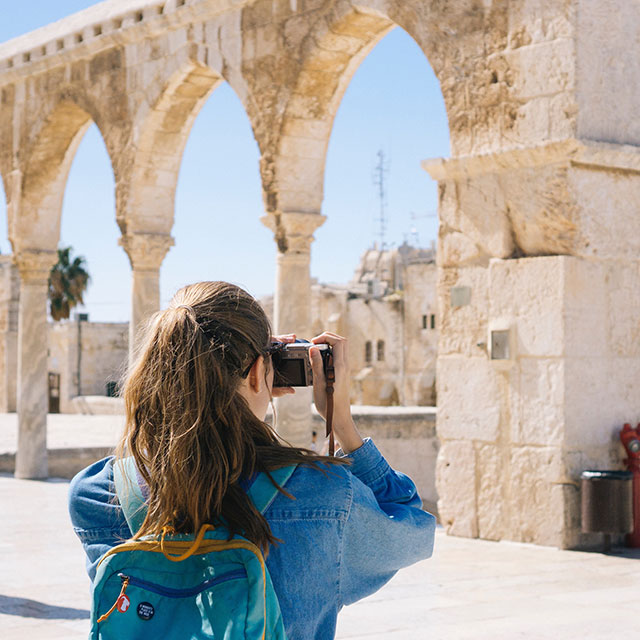 Tourist taking photo outside of historical archaeology site