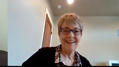 Debra Moddelmog smiles on Zoom screen
