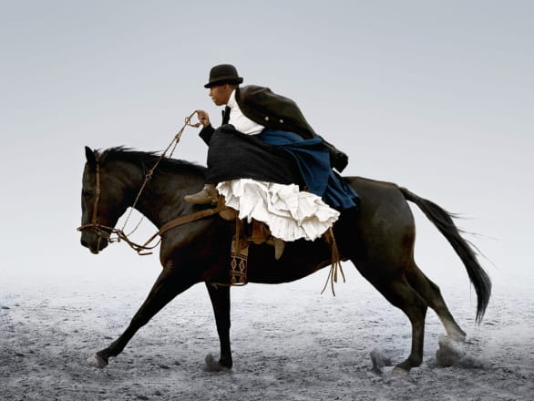 photograph of woman riding horse