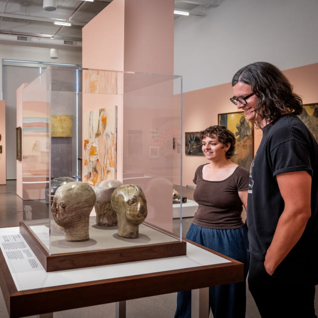 two people looking at display case in museum