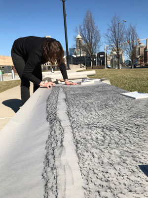 Nina making a rubbing of the crack. These breaks are caused by the slow seap or water and expansion of ice in winter.
