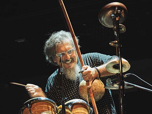 Musician Cyro Baptista playing the drums