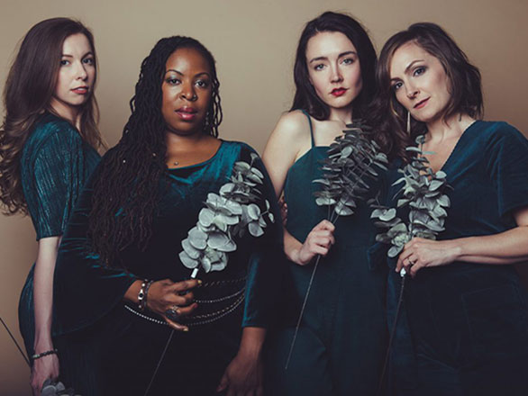 Members of the sage band hold up leafy branches