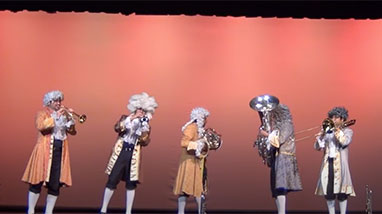 M5 Mexican Brass dresses up in 18th century attire and performs on stage