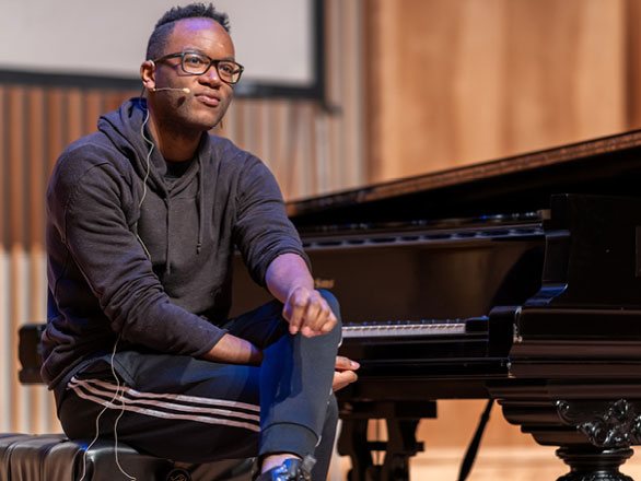 Man sitting near piano