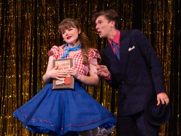 a man and woman acting on stage