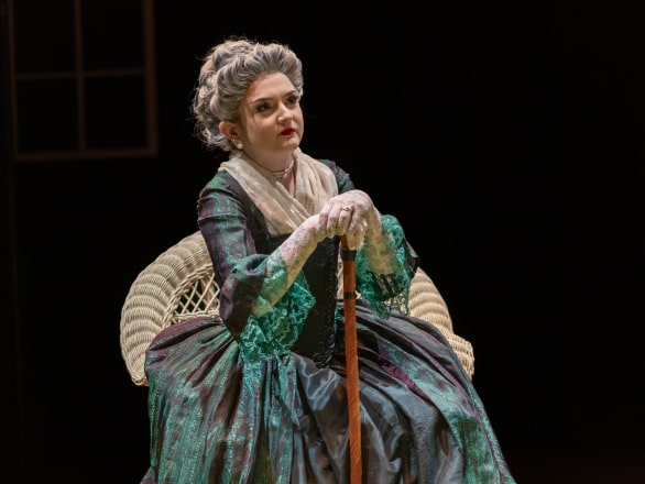 woman in dress and wig on stage