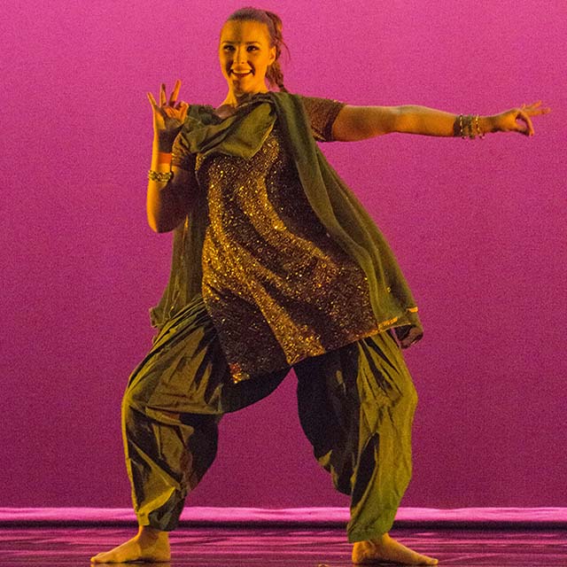 Dancer dressed in gypsy outfit dances on stage