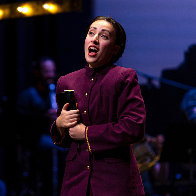woman in costume singing on stage