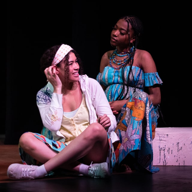 two women on stage acting