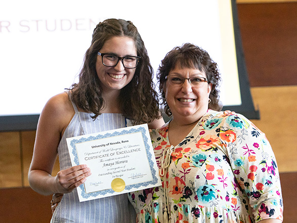 Student is given Basque award by professor during ceremony