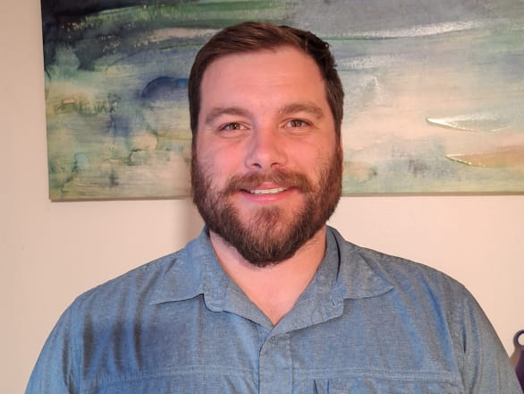 selfie of nick freed with blue and gold painting in background