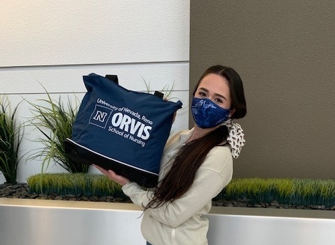 OSNA committee member stands alone with a supply bag