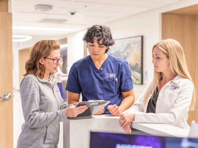 Two nurses and a student looking at information.