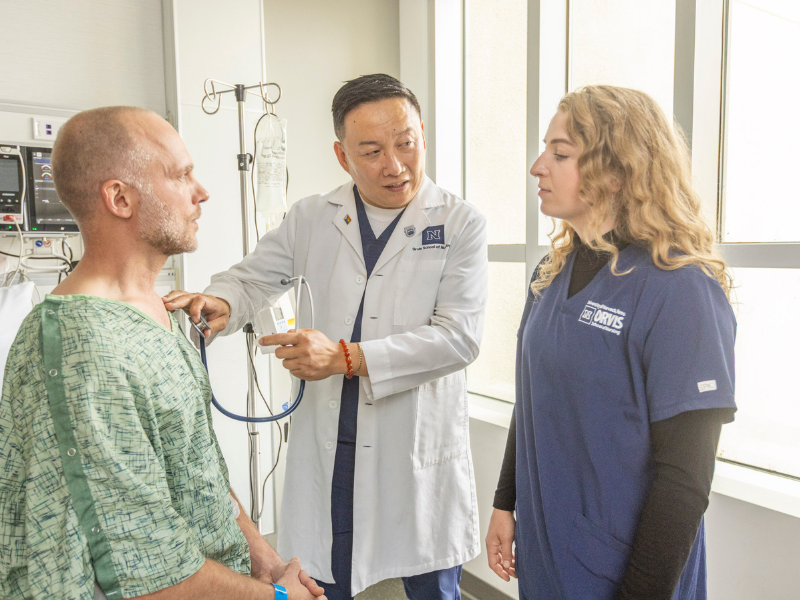 Nurse Practitioner and student examining a patient