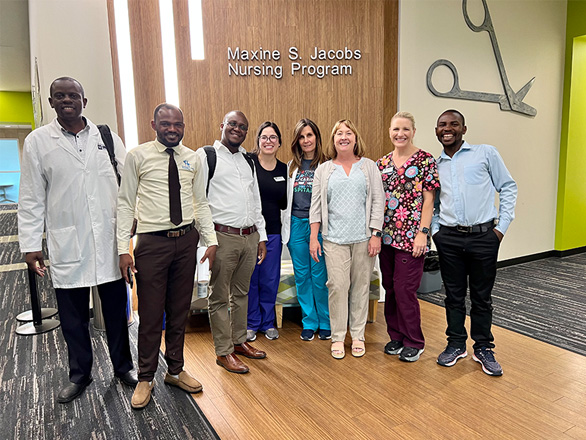 A group of Orvis nurses pose with colleagues from Bwindi Community Hospital for a group photo.