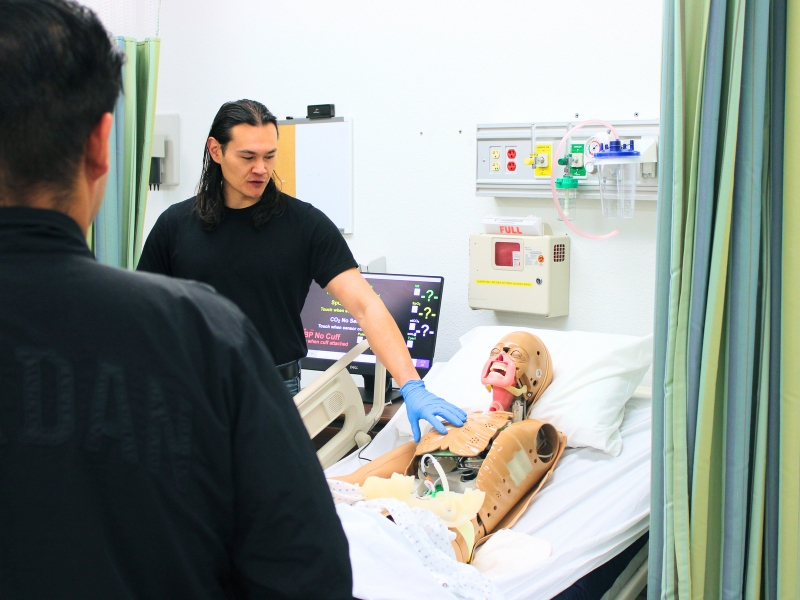 Three nursing students analyzing a note pad.