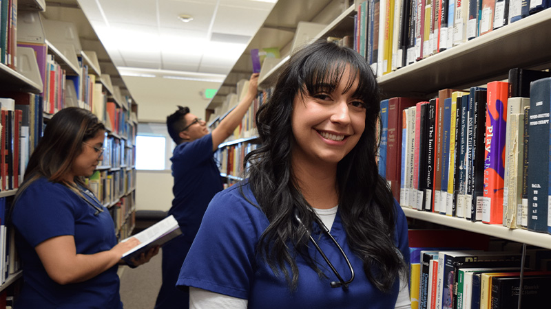 Smiling students in the University library.