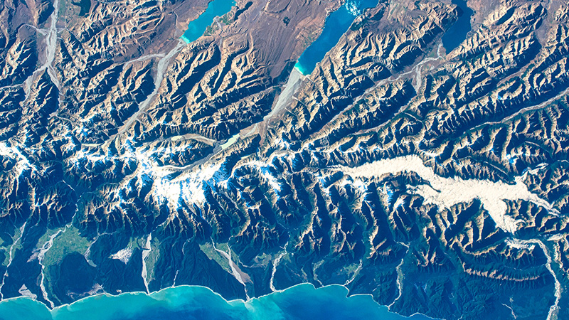 Aerial view of mountain ranges near a body of water