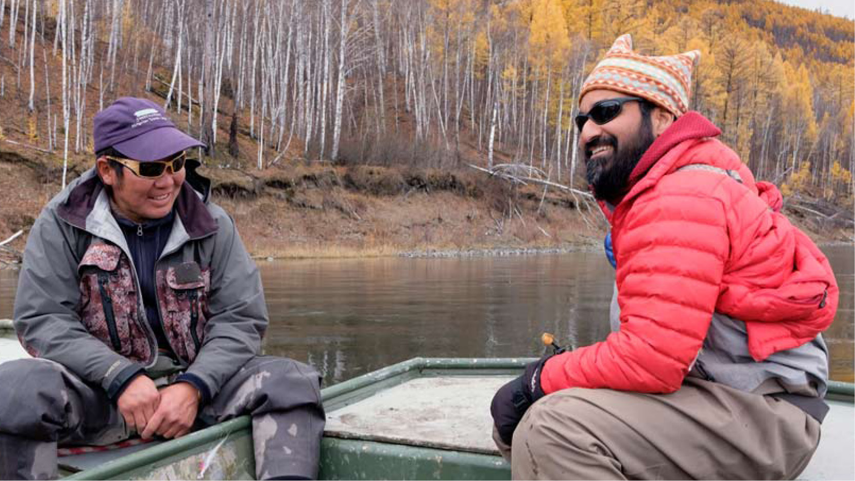 Sudeep Chandra on a boat with colleague conducting research