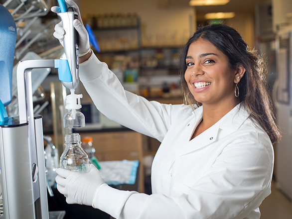 Student in a lab using equipment